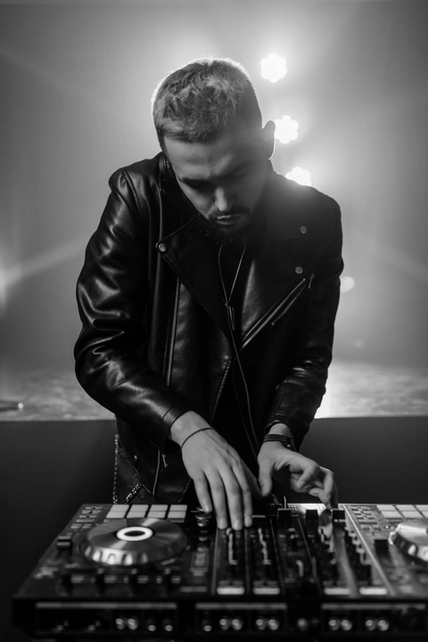 a photo of a dj in a leather jacket